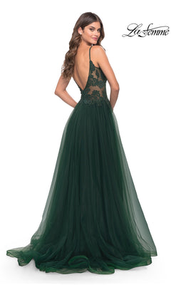 Woman wearing the Lace-Bodice Long Tulle Prom Dress: La Femme 31507, featuring a dark green lace bodice, thin straps, and open back, stands elegantly and looks over her shoulder in this formal gown.