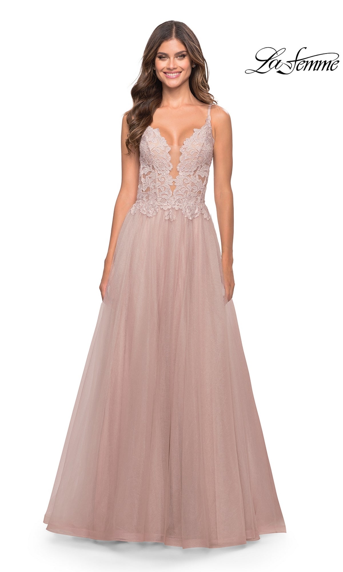 A woman in the La Femme 31507 Lace-Bodice Long Tulle Prom Dress in blush pink smiles while standing. The La Femme logo is visible in the top right corner.