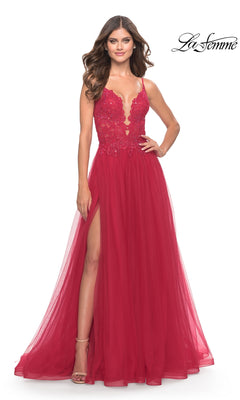 A woman in the Lace-Bodice Long Tulle Prom Dress: La Femme 31507 stands against a white background, showcasing its sleeveless deep v-neck, red floral lace bodice, and high slit.