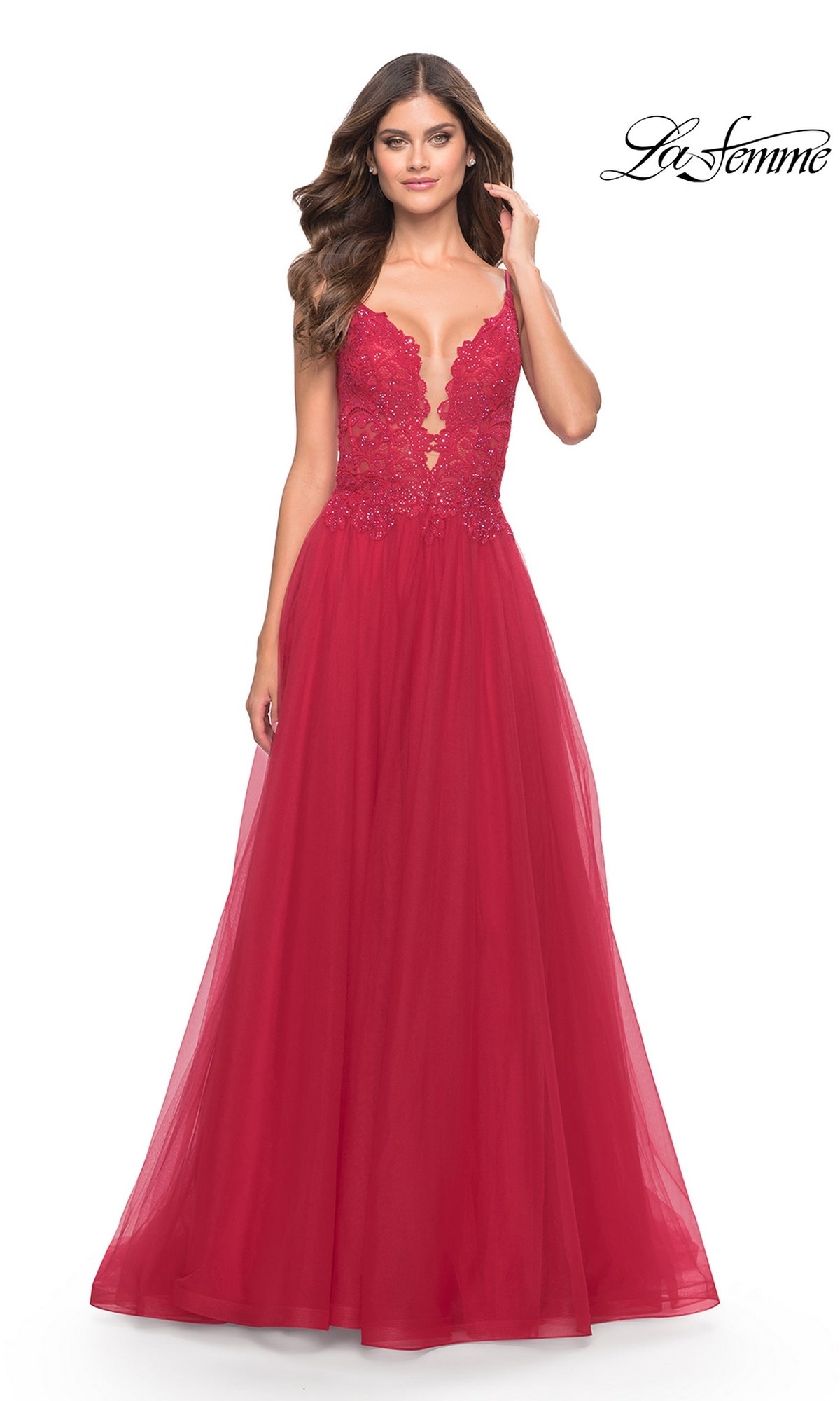 A woman models the Lace-Bodice Long Tulle Prom Dress, La Femme 31507—a floor-length red gown with a lace bodice and flowing A-line tulle skirt—standing against a white background with the 