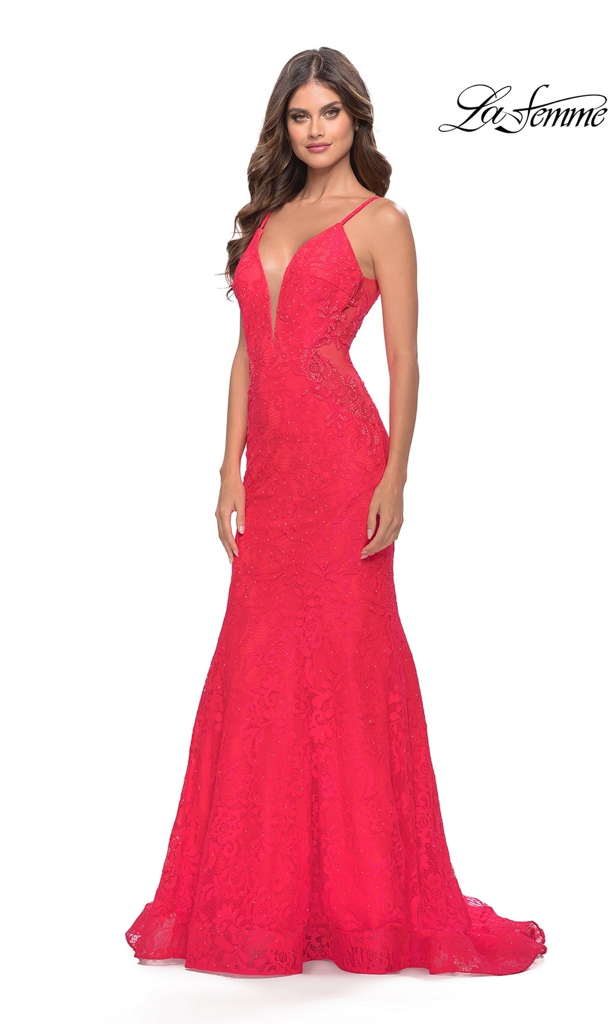 A woman stands against a white background wearing the Long Lace Mermaid Prom Dress: La Femme 31512, a sleeveless, floor-length red gown with a deep V neckline and thin straps. The 
