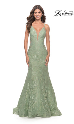 A woman wears the Long Lace Mermaid Prom Dress: La Femme 31512 in sage green, featuring a deep V neckline and thin straps, standing against a white background. The "La Femme" logo appears in the top right corner.