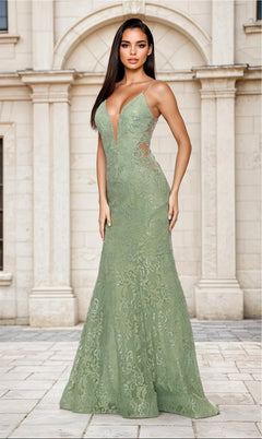A woman poses gracefully outdoors in the sage La Femme 31512 Long Lace Mermaid Prom Dress, featuring a sleeveless floor-length design, deep V neckline, side cutouts, and elegant backless detail before a stone building with arched windows.