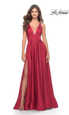 A woman wears the La Femme 31533 deep V-neck, sleeveless, floor-length red A-line prom dress with a high slit, posing against a white background.