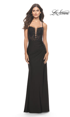 A woman models the La Femme Long Prom Dress 31567, featuring a black lace bodice and spaghetti straps; the fitted gown flows gracefully to the floor against a plain white background.