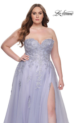 A woman models the La Femme Long Prom Dress 31570, a plus-size strapless gown with a corset bodice, silver embroidered lace, and thigh-high slit, standing against a white background. The La Femme logo appears in the upper right corner.