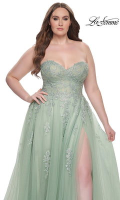 Woman wears the La Femme Long Prom Dress 31570—strapless, light green with a corset-style bodice, floral embroidery, and thigh-high slit—posing against a plain white background.