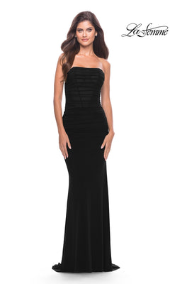 A woman models the Simple Strapless Long Prom Dress: La Femme 31584, showcasing its fitted bodice and floor-length black skirt against a white background. The "La Femme" logo is visible in the upper right corner.