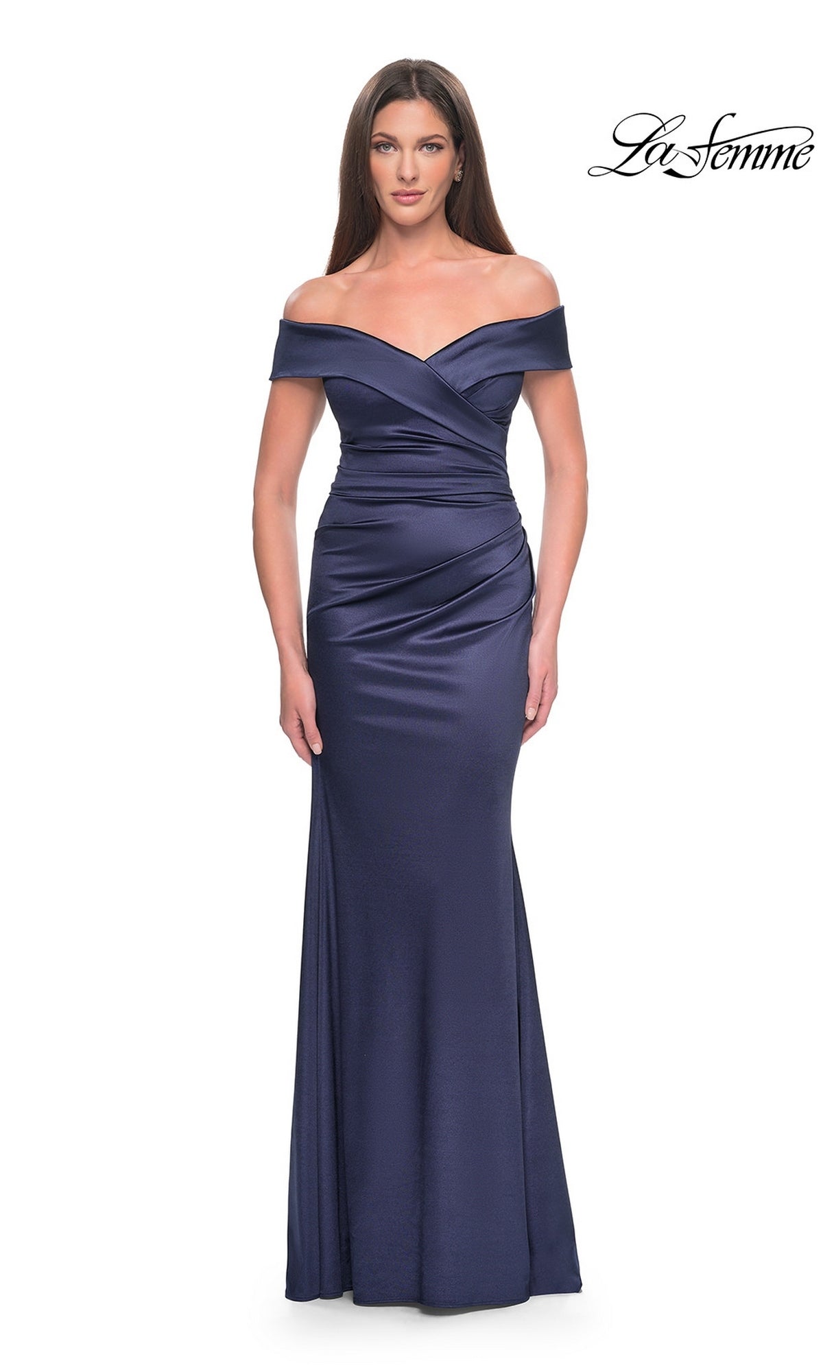 A woman wearing the Long Formal Dress: La Femme 31621, a navy, floor-length, off-the-shoulder gown in stretch-satin with a wrapped bodice.