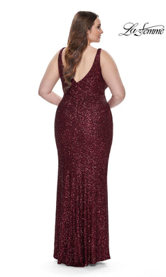 A woman models the La Femme Long Prom Dress 31630, a plus-size, sleeveless, floor-length red sequin gown with a low V-back, standing against a plain white background. The "La Femme" logo appears in the top right corner.