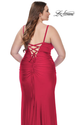 A woman models the La Femme Long Prom Dress 31632, a red empire-waist gown with a crisscross lace-up back and ruched detailing, viewed from behind. The La Femme logo appears in the top right corner.