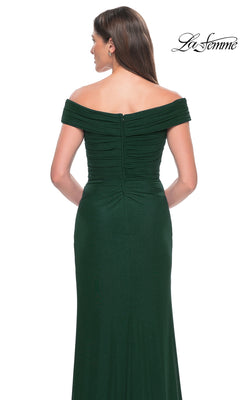 A woman is seen from the back wearing the La Femme Off-the-Shoulder Long Prom Dress 31677 in dark green, with the La Femme logo displayed in the top right corner.