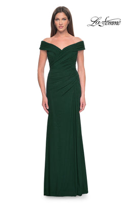 A woman models the La Femme Off-the-Shoulder Long Prom Dress 31677, a floor-length dark green gown with ruched detailing, against a white background. The "La Femme" logo is displayed in the top right corner, emphasizing this elegant evening dress.