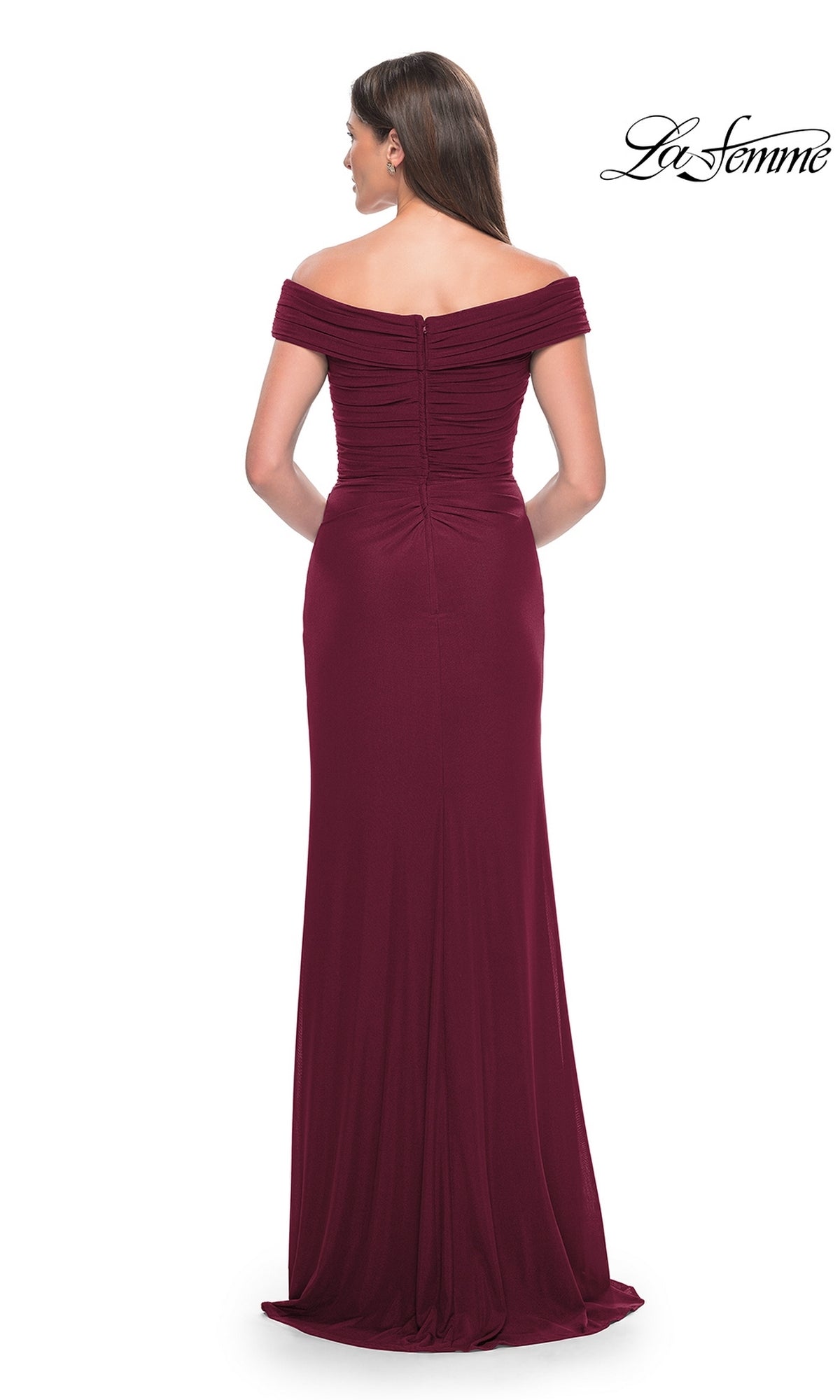 A woman is shown from the back in the La Femme Off-the-Shoulder Long Prom Dress 31677, a floor-length burgundy gown with a fitted bodice and zipper closure, set against a white background for an elegant look.
