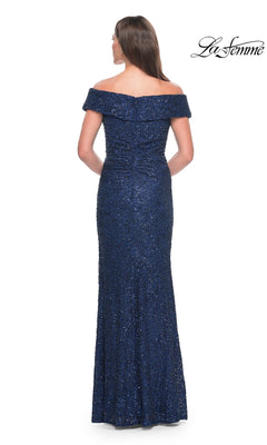 A woman viewed from behind wearing a floor-length, off-the-shoulder navy blue Long Formal Dress: La Femme 31679, covered in beaded lace and sequins.