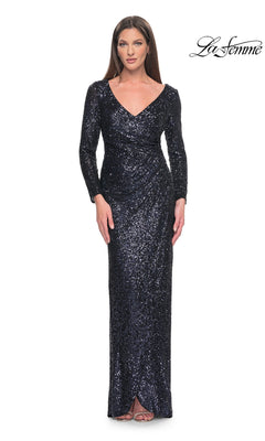 A model wearing a floor-length, navy blue long-sleeve sequin V-neck La Femme 31698 formal dress.