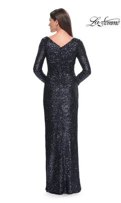 Back view of a woman in a Long Formal Dress: La Femme 31698, a fitted, floor-length, long-sleeve, navy blue sequin dress with a V-neckline.