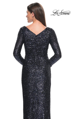 Back view of a person wearing a Long Formal Dress: La Femme 31698, a long-sleeve sequin formal dress with a V-neckline.