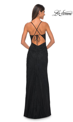 A woman faces away, wearing the La Femme Sheer-Corset Long Beaded Prom Dress 31701 with crisscross spaghetti straps and subtle embellishments. The La Femme logo appears in the top right corner.