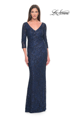 A model wears the La Femme 31721 long formal dress, a navy blue, sequined, floor-length beaded lace gown with a V-neck and three-quarter-length sleeves.