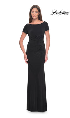 A woman wearing a black Long Formal Dress: La Femme 31773, a long jersey formal dress with short sleeves and side ruching.
