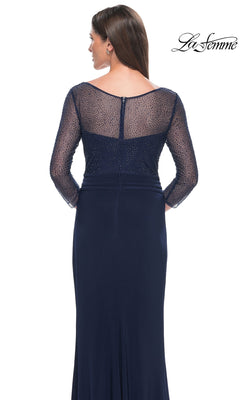 Back view of a woman wearing a navy blue La Femme 31777 long formal dress, featuring a sheer, beaded three-quarter sleeve bodice.