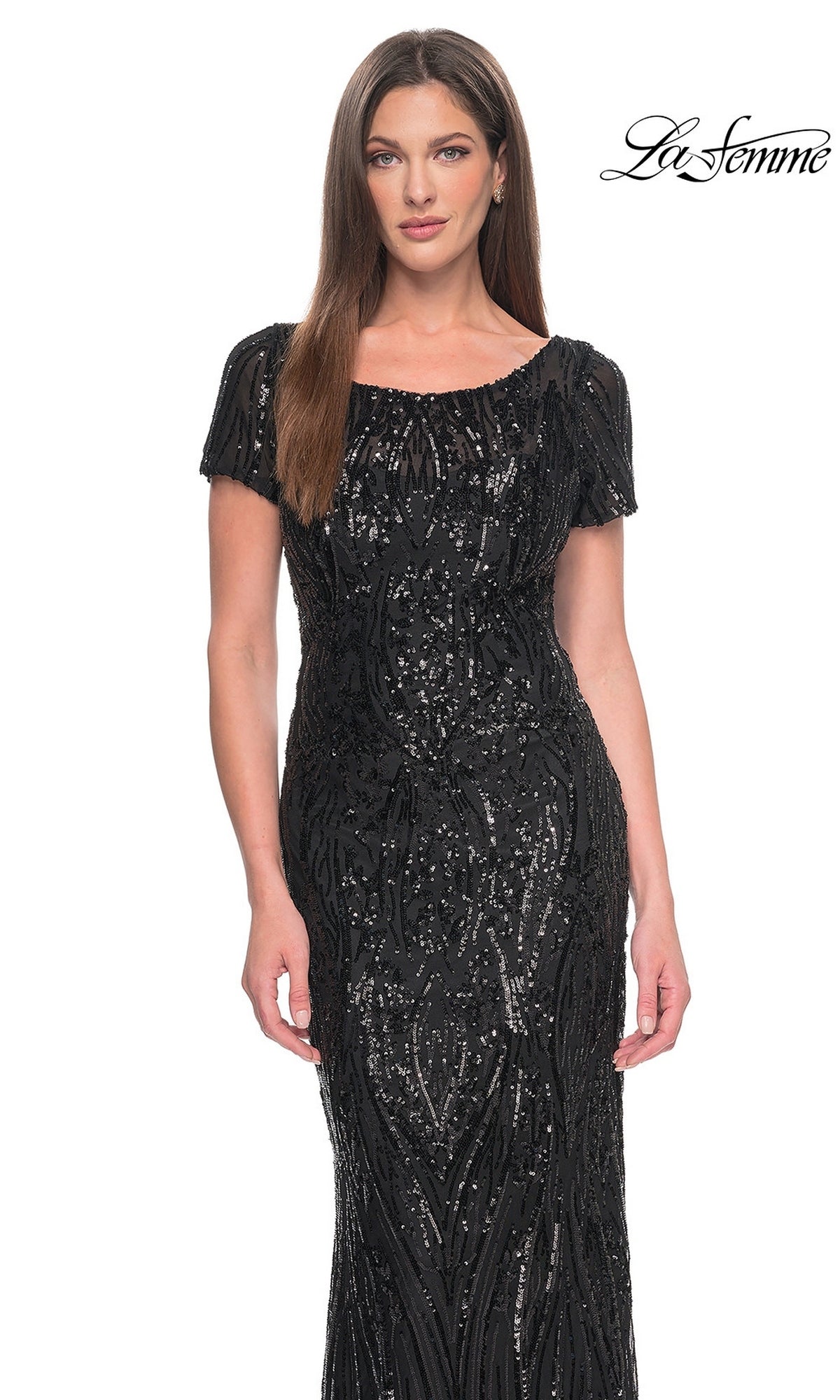 A woman wearing a black, short-sleeved, floor-length La Femme 31852 gown covered in vertical sequin patterns.
