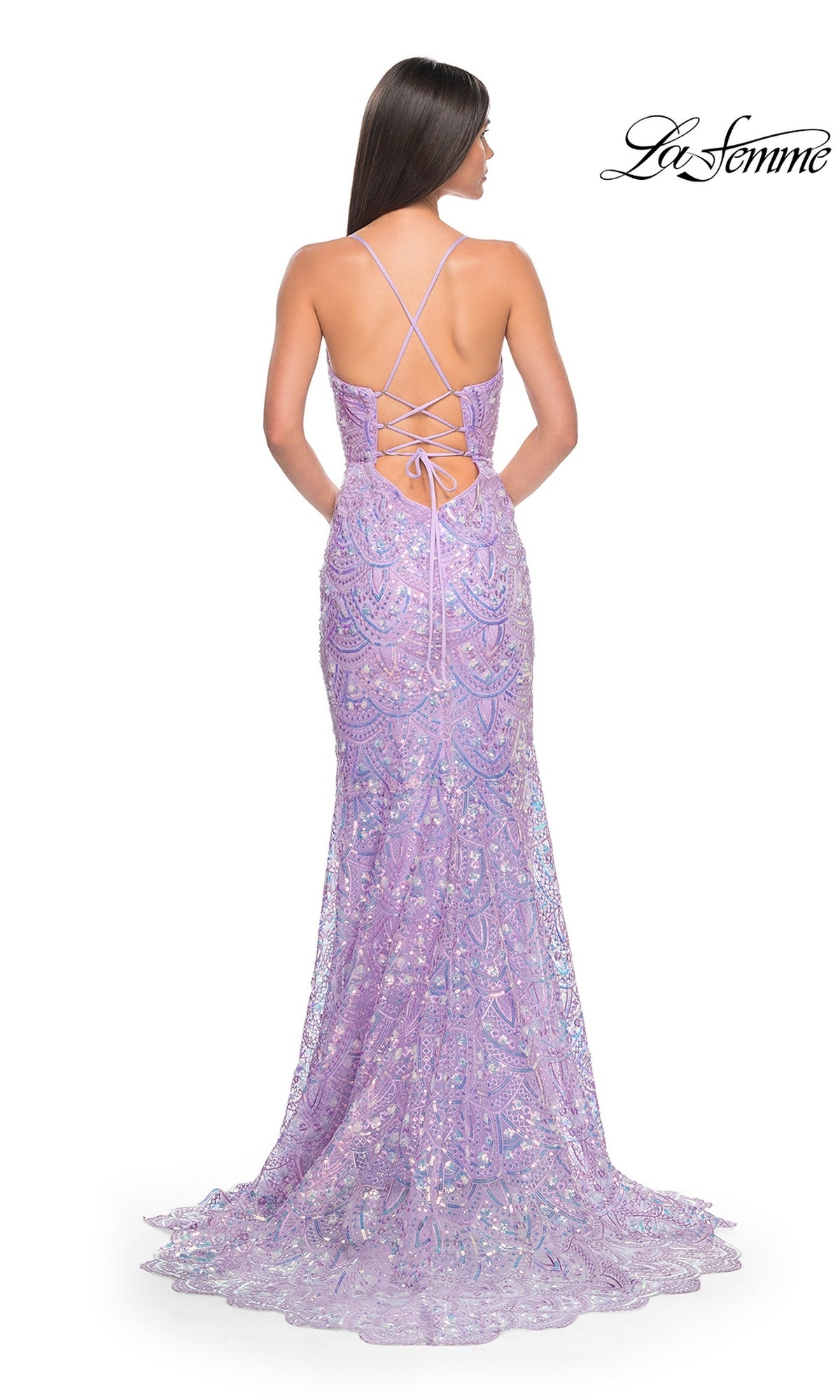 A woman faces away in the La Femme Sequin-Print Long Prom Dress 31865, featuring lilac sequins, a lace-up open back with thin crisscross straps, and a gently flared, elegant floor-length silhouette.