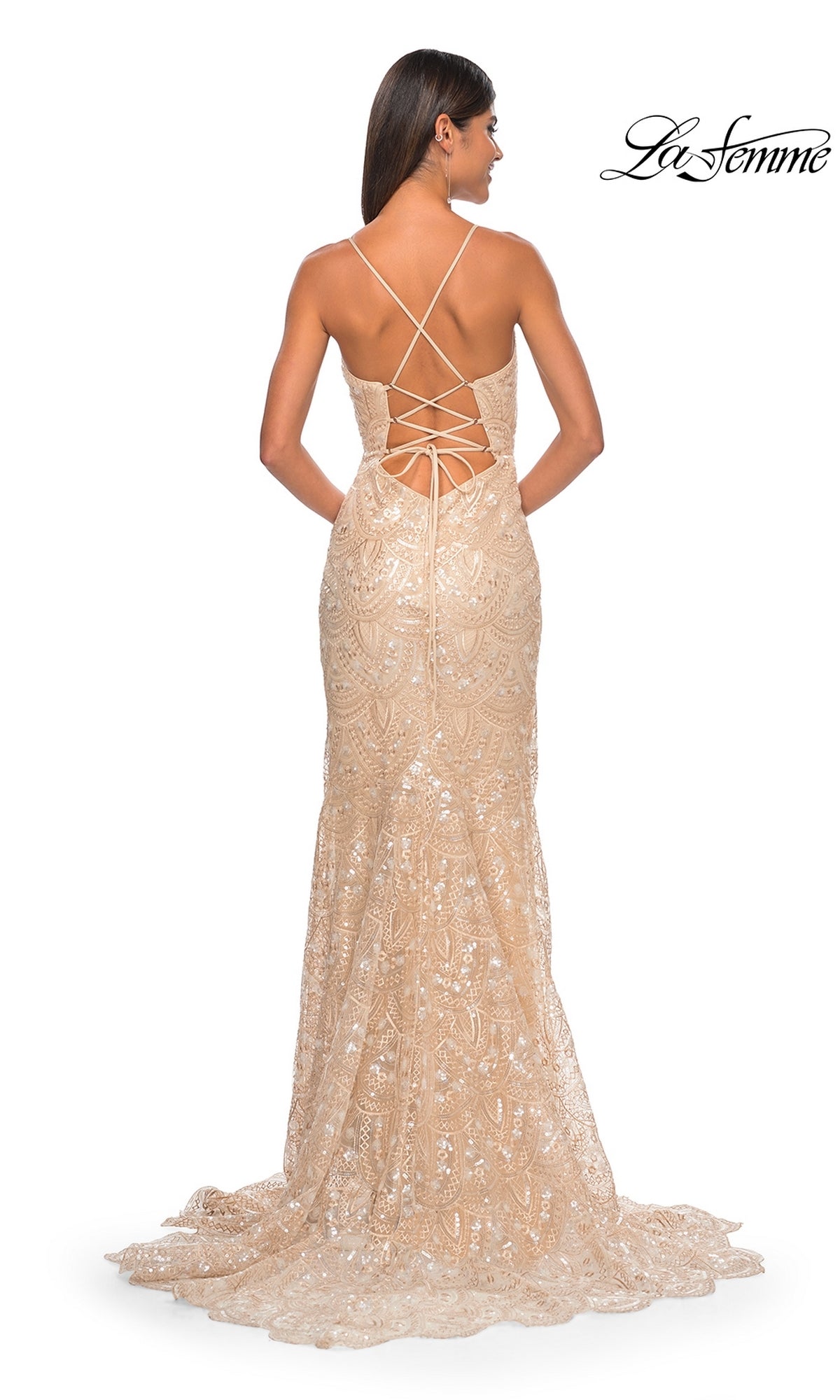 A woman wears the La Femme Sequin-Print Long Prom Dress 31865—a nude, floor-length fitted gown with elegant lace, shimmering sequins, and a crisscross lace-up back. La Femme logo appears in the top right corner.