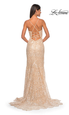 A woman wears the La Femme Sequin-Print Long Prom Dress 31865—a nude, floor-length fitted gown with elegant lace, shimmering sequins, and a crisscross lace-up back. La Femme logo appears in the top right corner.
