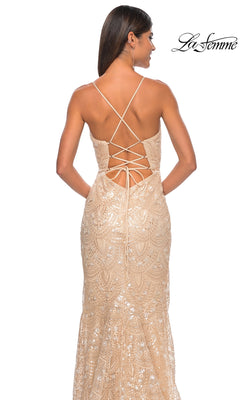 A woman models the La Femme Sequin-Print Long Prom Dress 31865, featuring a beige sequined design, lace-up open back, and thin straps. She stands facing away from the camera with the La Femme logo in the upper right corner.
