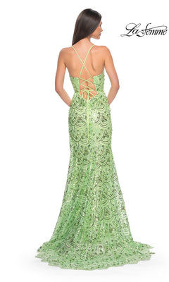 Woman in the La Femme Sequin-Print Long Prom Dress 31865, light green with lace mermaid silhouette, open back, and crisscross lacing, stands facing away from the camera.