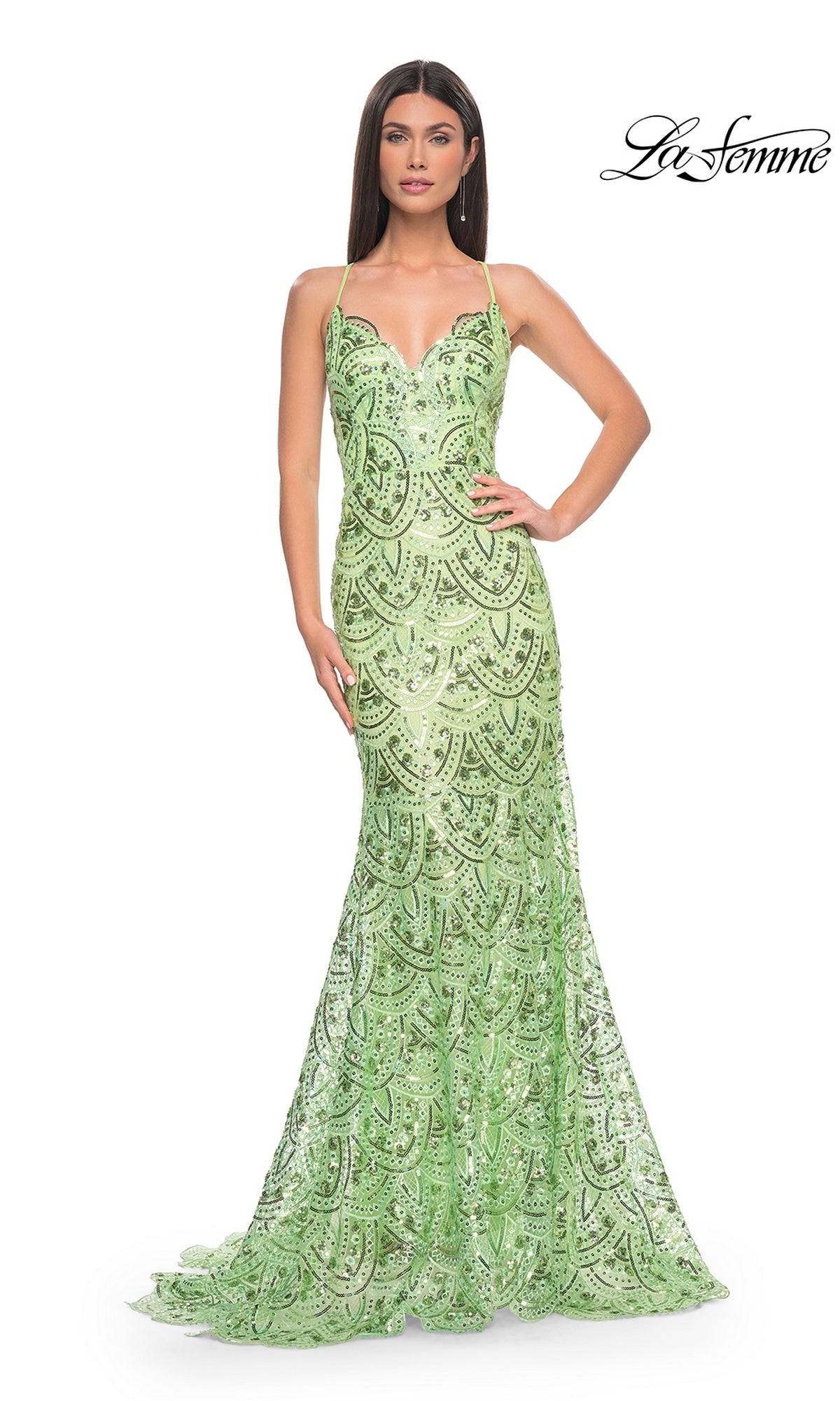 A woman poses with one hand on her hip in the La Femme Sequin-Print Long Prom Dress 31865, a fitted, floor-length gown with thin straps, against a plain white background.