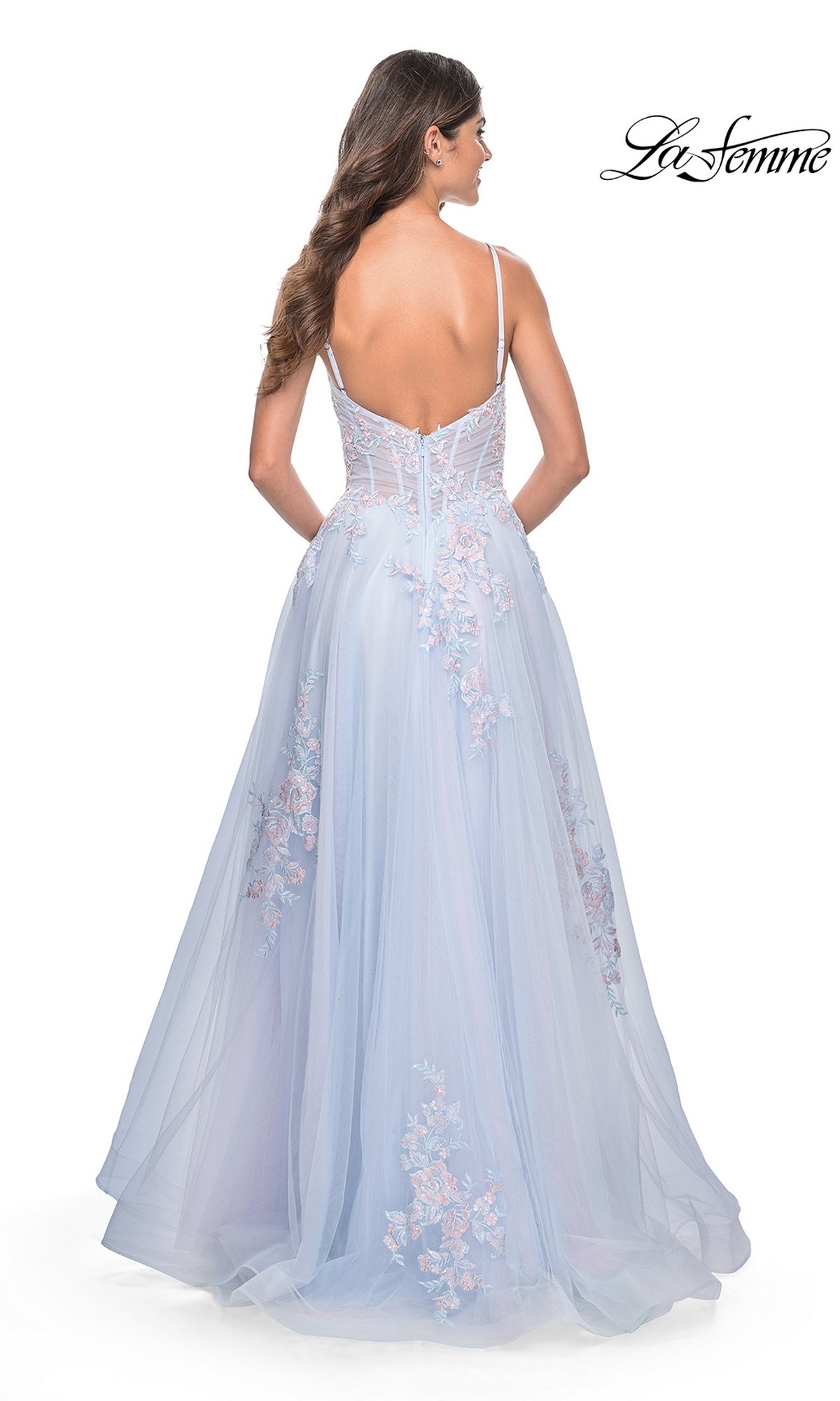 A woman with long hair, seen from behind, models the La Femme Embroidered-Lace Long Prom Dress 31939 in light blue, featuring a floor-length skirt, thin straps, embroidered floral lace accents, and a low back.