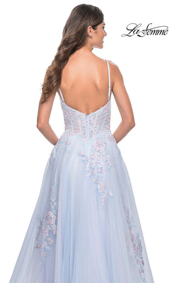 A woman with long brown hair models the La Femme Embroidered-Lace Long Prom Dress 31939 in light blue, featuring thin straps and delicate floral embroidery. She is shown from the back, with the La Femme logo in the top right corner.