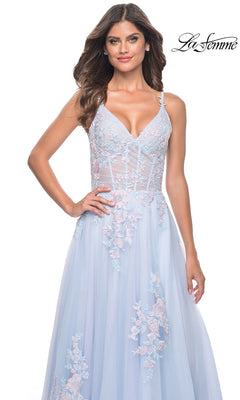 A woman models the La Femme Embroidered-Lace Long Prom Dress 31939 in light blue, featuring a sleeveless V-neck and sheer bodice, against a white background. "La Femme" logo appears in the top right corner.
