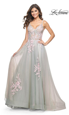 A woman wears the La Femme Embroidered-Lace Long Prom Dress 31939 in pastel green, featuring pink floral embroidery and elegant lace details, while standing and holding the skirt. The La Femme logo is in the top right corner.