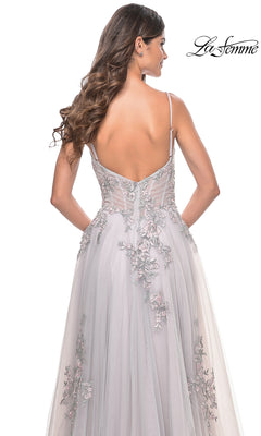 A woman with long wavy hair is shown from the back wearing the La Femme Embroidered-Lace Long Prom Dress 31939, a backless light gray gown featuring sheer fabric and intricate floral lace embroidery.