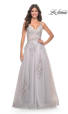 A woman in the La Femme Embroidered-Lace Long Prom Dress 31939, light gray and floor-length with thin straps, stands facing forward and smiling. The "La Femme" logo is in the top right corner.