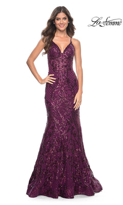 A woman poses and smiles in the La Femme Sequin-Print Long V-Neck Prom Dress 31943, featuring a deep purple mermaid skirt and thin straps, against a white background. "La Femme" appears in the top right corner.