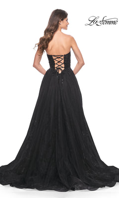 Woman wearing the La Femme Strapless Long Prom Ball Gown 31954 with a lace-up corset back, standing and facing away; La Femme logo is in the top right corner.