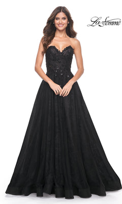 A woman models the La Femme Strapless Long Prom Ball Gown 31954, featuring lace and sequin details, smiling against a white background with the "La Femme" logo in the top right corner.