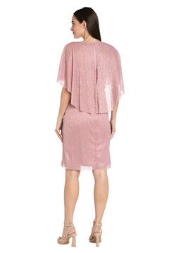 Woman facing away, wearing the Caped Knee-Length Party Dress: R&M Richards 3195P—shimmery pink chiffon, petite fit, knee-length with a cape overlay—paired with beige heeled sandals.