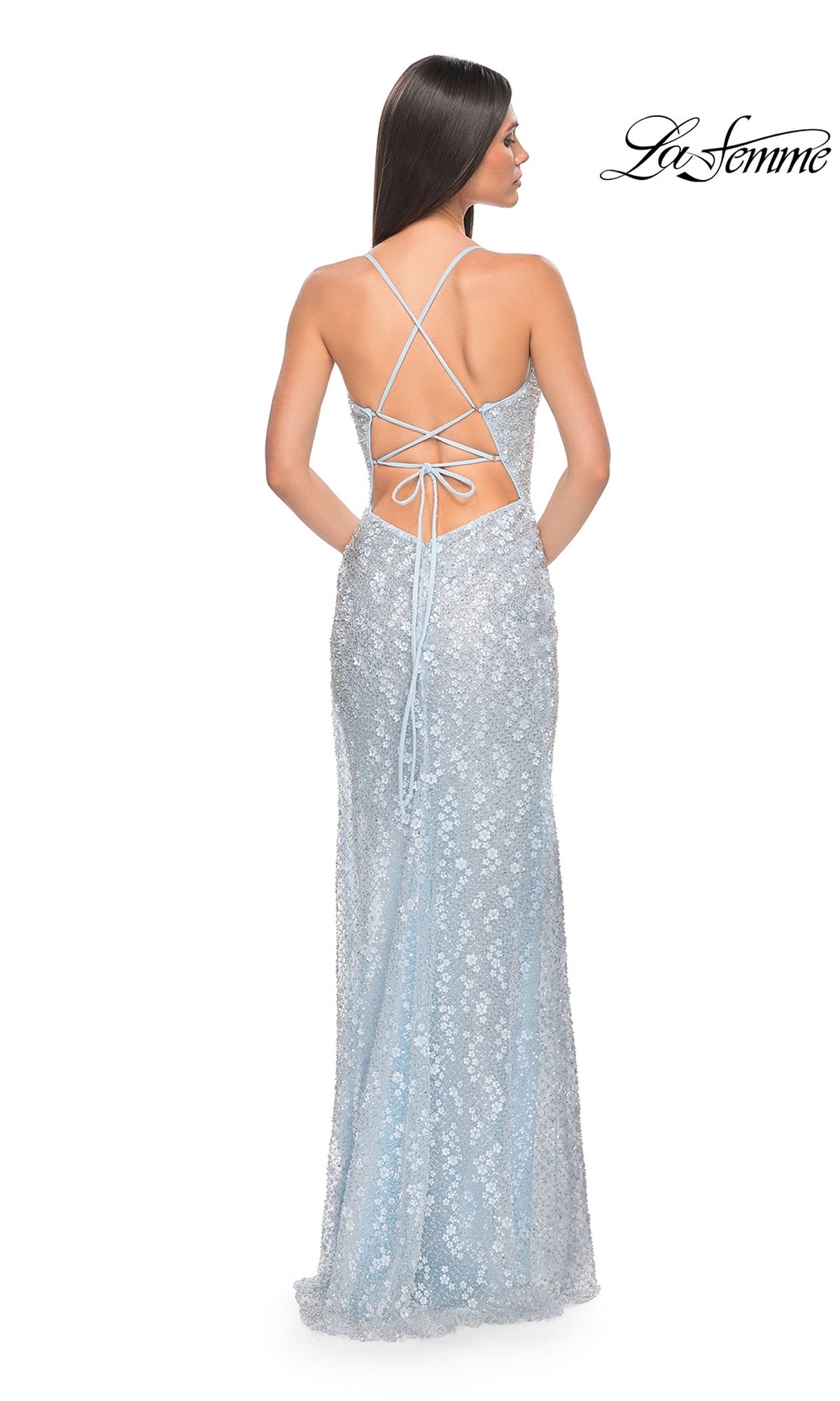 Woman in a light blue Strappy-Back Long La Femme Beaded Prom Dress 31993 with sequins and an open back, standing and facing away. La Femme logo appears in the top right corner.