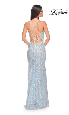 Woman in a light blue Strappy-Back Long La Femme Beaded Prom Dress 31993 with sequins and an open back, standing and facing away. La Femme logo appears in the top right corner.