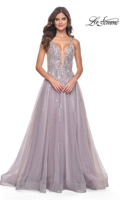 A woman models the Sequined Long Mauve Prom Dress: La Femme 31995, featuring a floor-length tulle skirt, deep V-neckline, and sparkling sequin embellishments, against a plain white background.