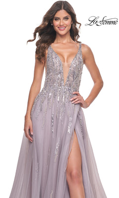 A woman wears the Sequined Long Mauve Prom Dress: La Femme 31995, featuring a sleeveless design, deep V-neckline, high slit, and silver embellishments. The La Femme logo appears in the top right corner.