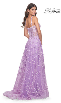 Woman wearing the La Femme Floral-Embellished Long Prom Dress 31996, featuring floral lace, a sheer back, and thin straps, standing and looking over her shoulder.