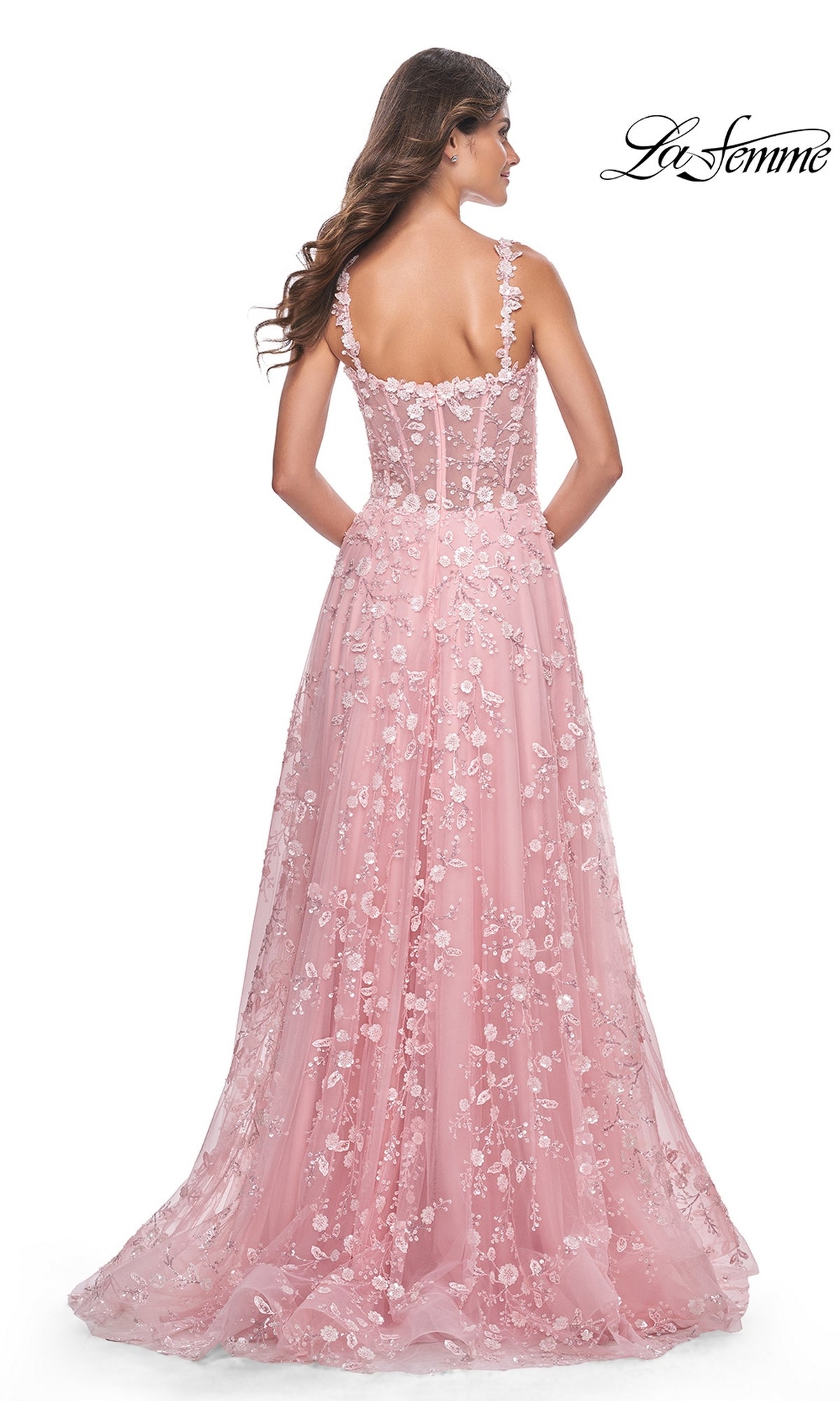 A woman is shown from the back in the La Femme Floral-Embellished Long Prom Dress 31996, featuring pink floral embroidery, sheer straps, and a fitted bodice.
