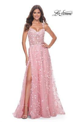 A woman smiles against a white background wearing the La Femme Floral-Embellished Long Prom Dress 31996—pink, sleeveless, with a thigh-high slit. The La Femme logo is displayed in the top right corner.